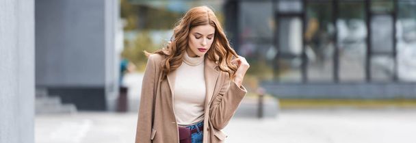 panoramic shot of attractive woman with closed eyes in coat - 写真・画像