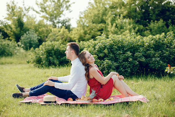Beautiful couple spend time on a summer field - Fotoğraf, Görsel
