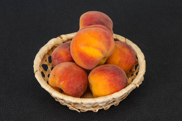 Peach heap in the wooden basket - Photo, Image