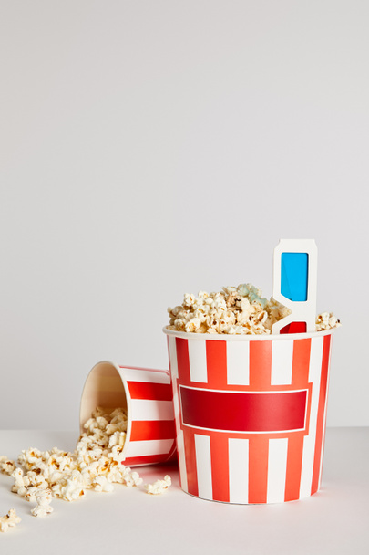 tasty fresh popcorn in buckets with 3d glasses isolated on grey - Fotoğraf, Görsel