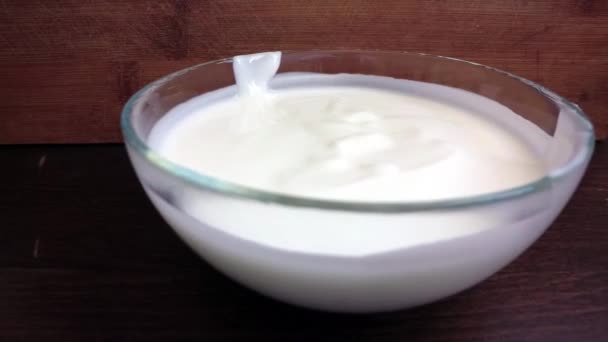 Joghurt van az asztalon. Tejföl egy tányérban. - Felvétel, videó