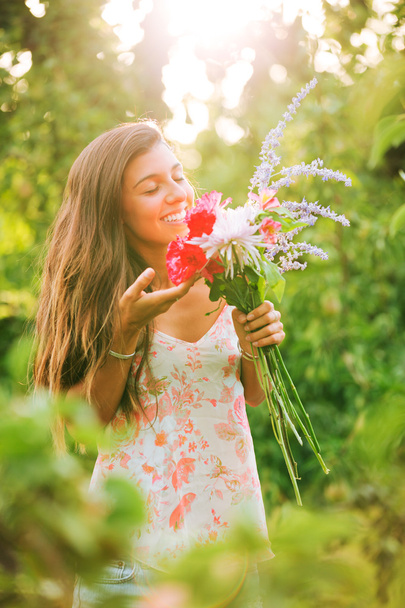 Young Woman with Flowers - Zdjęcie, obraz