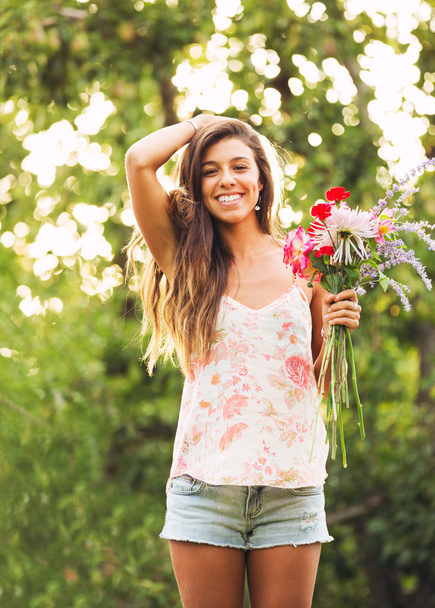 Young Woman with Flowers - Фото, изображение