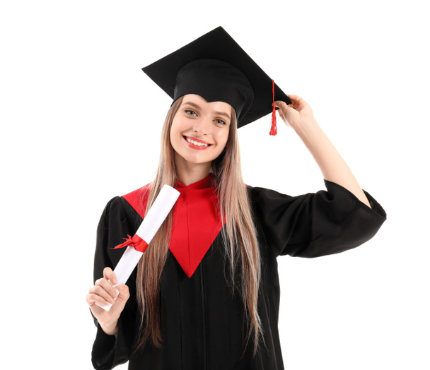 Young female student in bachelor robe and with diploma on white background - 写真・画像