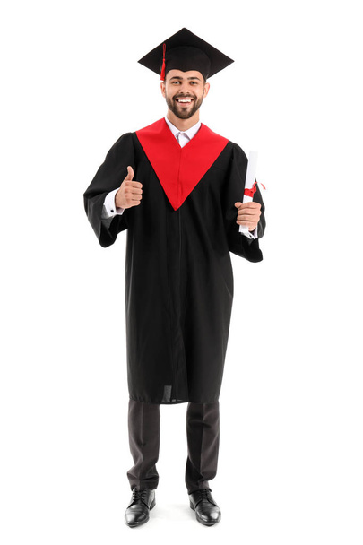 Young male student in bachelor robe on white background - Valokuva, kuva