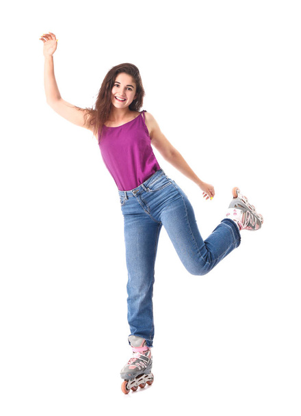 Teenage girl on roller skates against white background - Фото, изображение