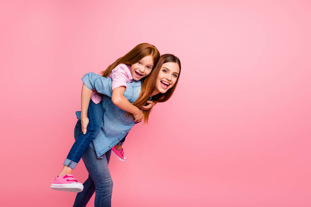 Funny foxy little lady and her mom spending weekend together wear casual clothes isolated pink background - Fotó, kép