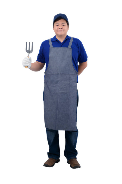 asiático trabajador hombre en azul camisa con delantal y protector guantes
  - Foto, imagen