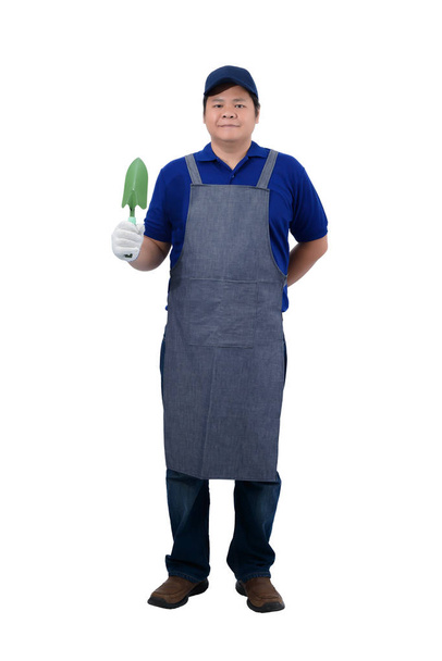 asiático trabajador hombre en azul camisa con delantal y protector guantes
  - Foto, Imagen