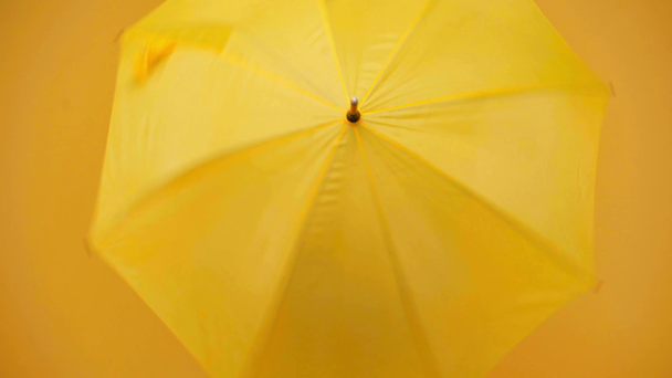 happy preteen child in blue dress spinning yellow umbrella - Πλάνα, βίντεο