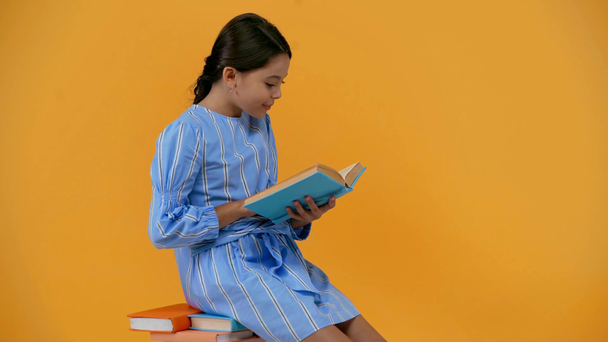 Emotionales Schulmädchen im blauen Kleid liest Buch - Filmmaterial, Video