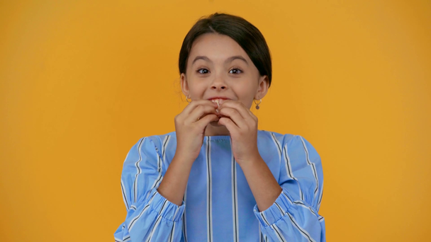 happy child eating bubble gum isolated on yellow - Footage, Video