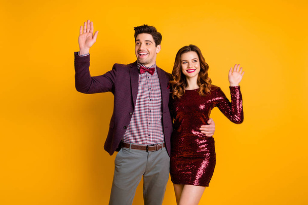 Portrait of his he her she nice-looking attractive elegant smart cheerful friendly people spending holiday waving greetings isolated over bright vivid shine yellow background - Фото, зображення