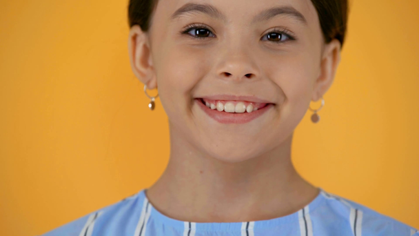 shy smiling preteen child isolated on yellow - Video, Çekim