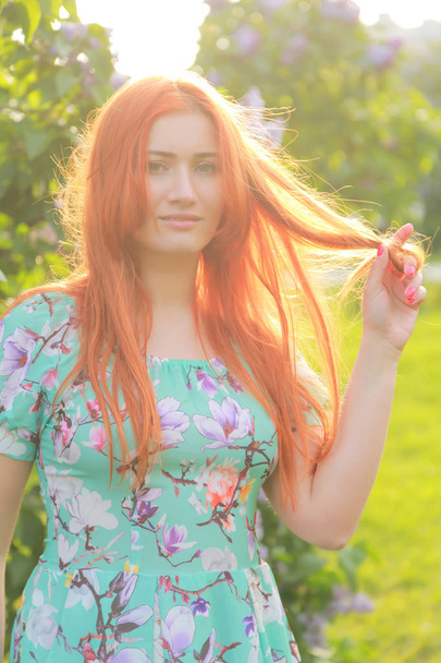 pretty redheaded girl walking in the summer park - Valokuva, kuva