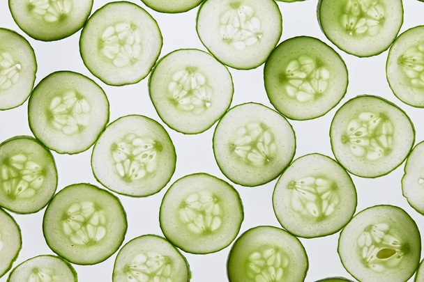 Fresh cucumber slices on a white background - Fotó, kép