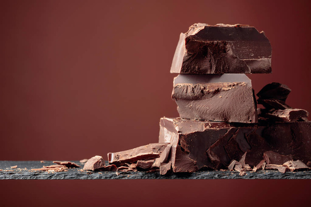 Black chocolate on a brown background.  - Photo, Image