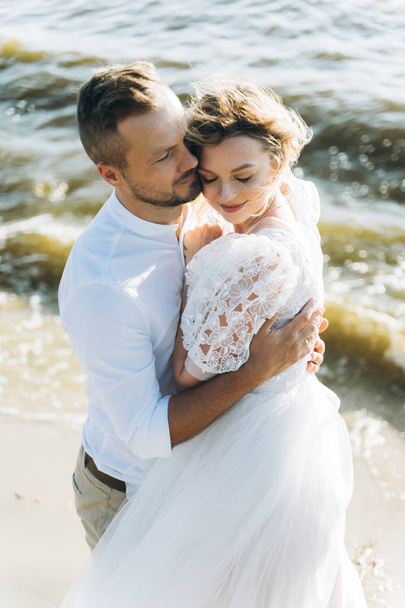 portrait of happy couple hugging on the beach  - Photo, image