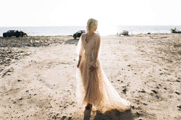 Full Length shot of happy stylish woman in dress walking on the beach  - Valokuva, kuva
