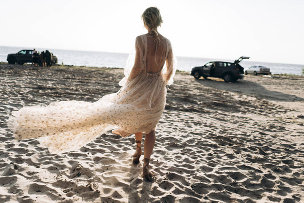 caucasian woman in beautiful dress walking on the beach  - Fotografie, Obrázek