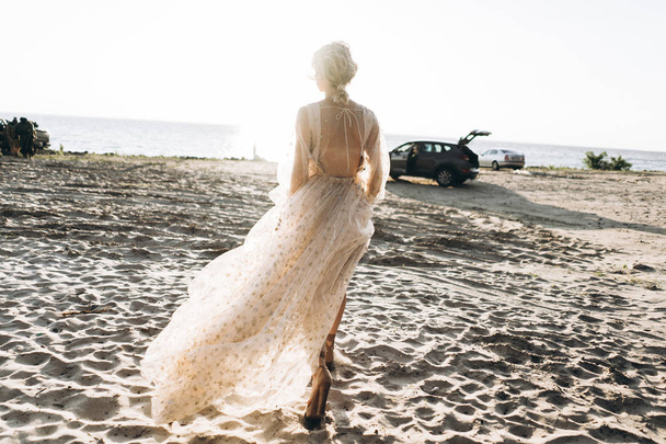beautiful young woman in long dress walking on the beach  - Foto, Imagem
