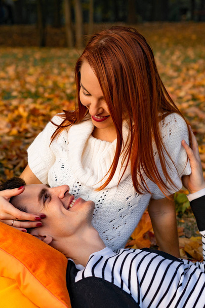 young couple in love. Lovers man and woman in the park in autumn, tenderness, hugs and kisses, happy couple. - Valokuva, kuva