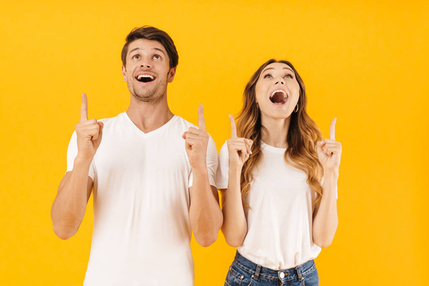 Portrait of content surprised couple man and woman in basic t-sh - Фото, изображение