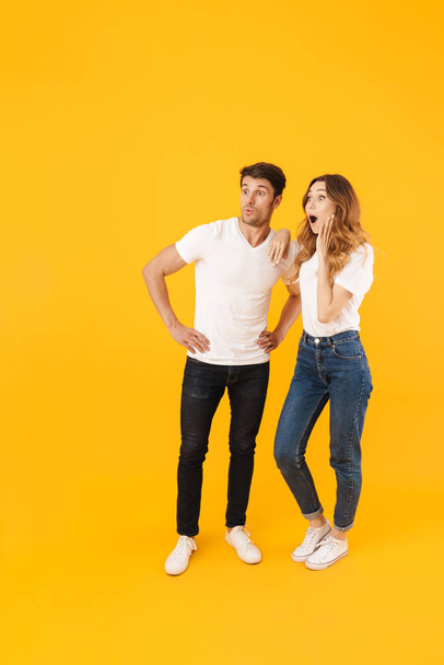 Full length portrait of delighted couple man and woman in basic  - Foto, Imagem