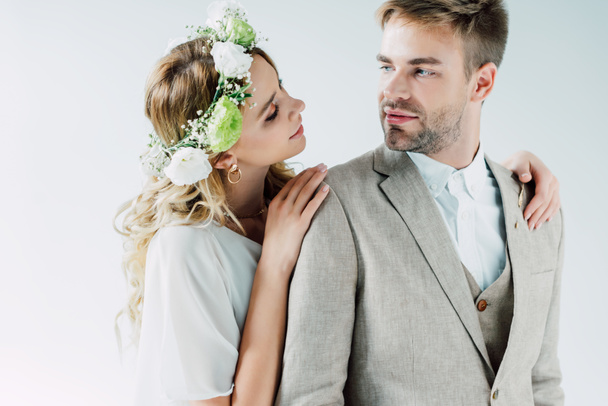 attractive bride and handsome bridegroom hugging and looking at each other  - Foto, Bild