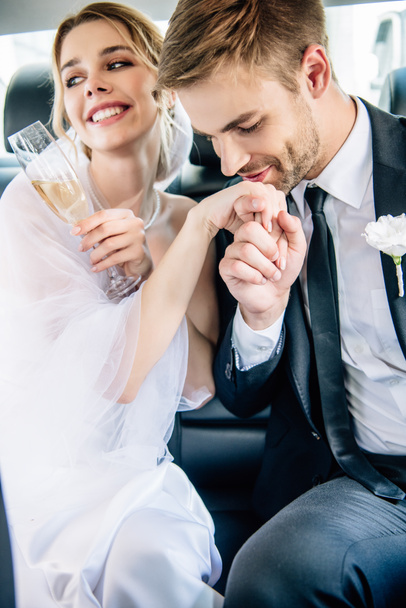 beau marié en costume baisant la main de sa belle mariée
  - Photo, image