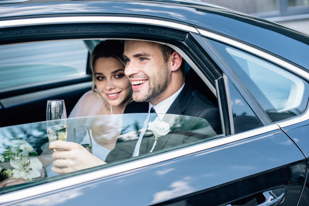 attractive bride and handsome bridegroom holding champagne glass - 写真・画像