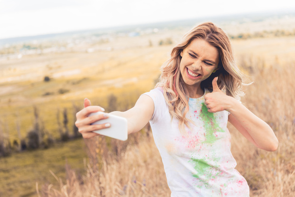 attractive woman in t-shirt taking selfie and showing thumb up - Photo, Image