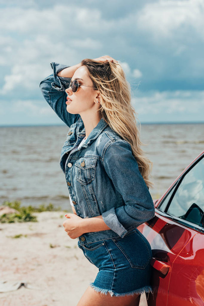 attractive woman in denim jacket and shorts looking away - 写真・画像