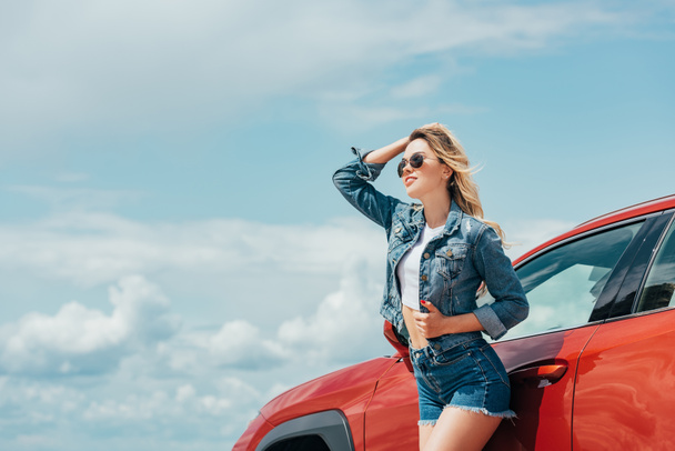 attractive woman in denim jacket and shorts looking away - Foto, Imagem