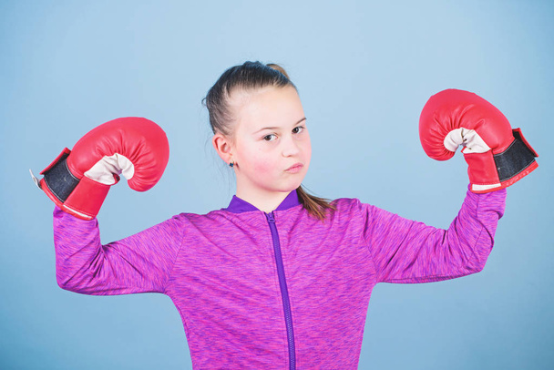 Female boxer. Sport upbringing. Boxing provide strict discipline. Girl cute boxer on blue background. With great power comes great responsibility. Contrary to stereotype. Boxer child in boxing gloves - Foto, Bild