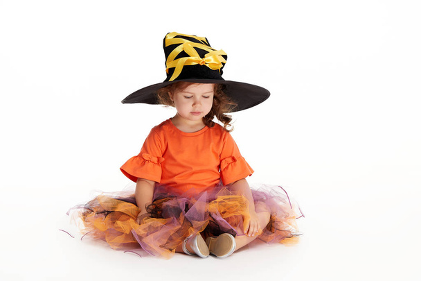 Happy Halloween party. Funny child girl in witch costume for Halloween on white isolated background. trick or treat - Fotografie, Obrázek