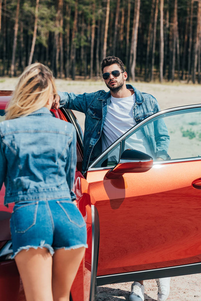 woman and handsome man in jacket standing near car - Foto, Imagen