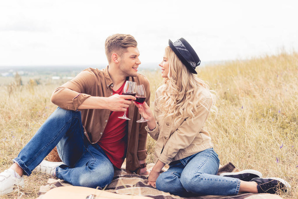 handsome man and attractive woman clinking with wine glasses - Fotoğraf, Görsel