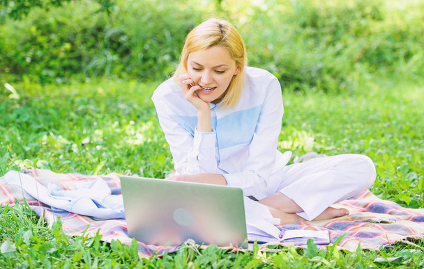 Business picnic concept. Steps to start freelancing business. Woman with laptop or notebook sit on rug green grass meadow. Business lady freelancer work outdoors. Online business ideas concept - Photo, Image