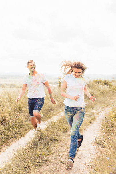 attractive woman and handsome man smiling and running outside  - 写真・画像
