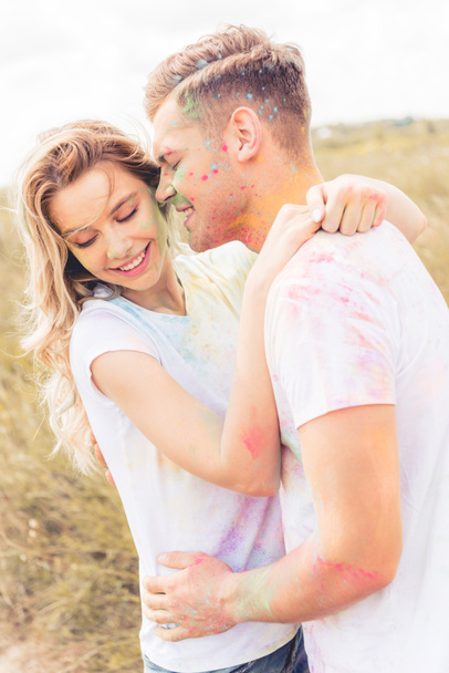 attractive woman and handsome man smiling and kissing outside  - Fotoğraf, Görsel