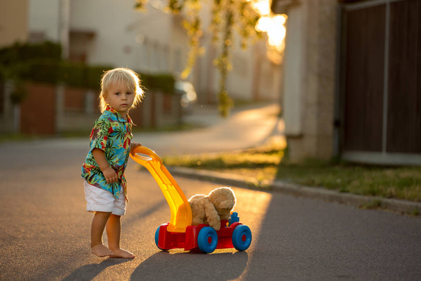 Beautiful toddler child, playing with plastic toys, blocks, cars - Φωτογραφία, εικόνα