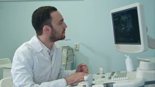 Young doctor with ultrasound diagnostic machine - Footage, Video