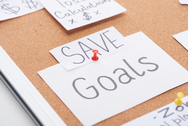 paper cards with save and goal inscriptions pinned on cork office board - Photo, Image