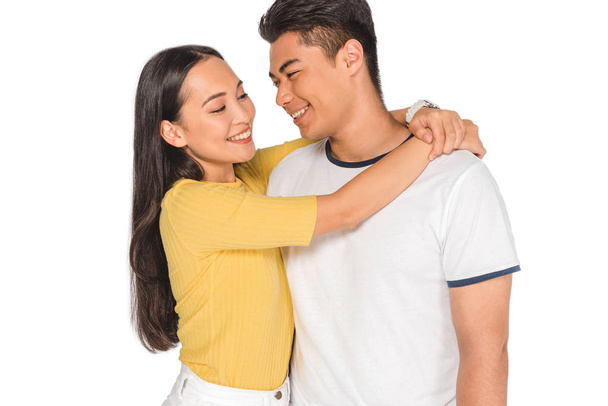 beautiful asian girl embracing handsome boyfriend isolated on white - Zdjęcie, obraz