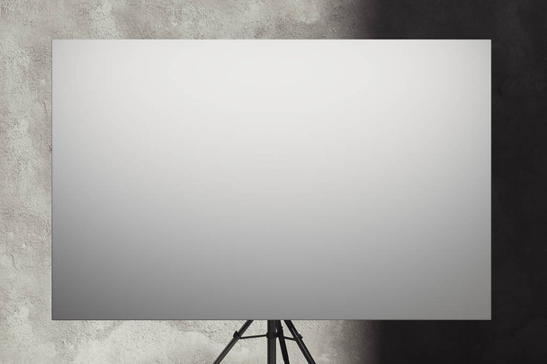 Blank easel with white canvas on concrete gray background. 3D rendering. - Photo, Image