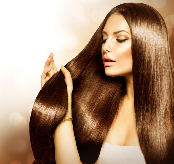 Beauty Woman touching her Long and Healthy Brown Hair - Photo, Image