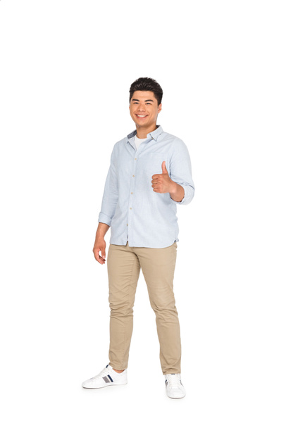 handsome asian man showing thumb up while smiling at camera on white background  - Foto, Imagem