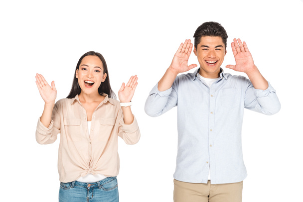 happy asian man and woman waving hands while looking at camera isolated on white - Photo, Image