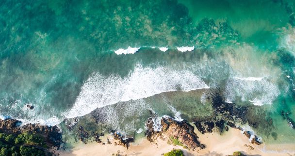 Aerial drone view of indian ocean on sunny tropical paradise island with aqua blue sea water - 写真・画像